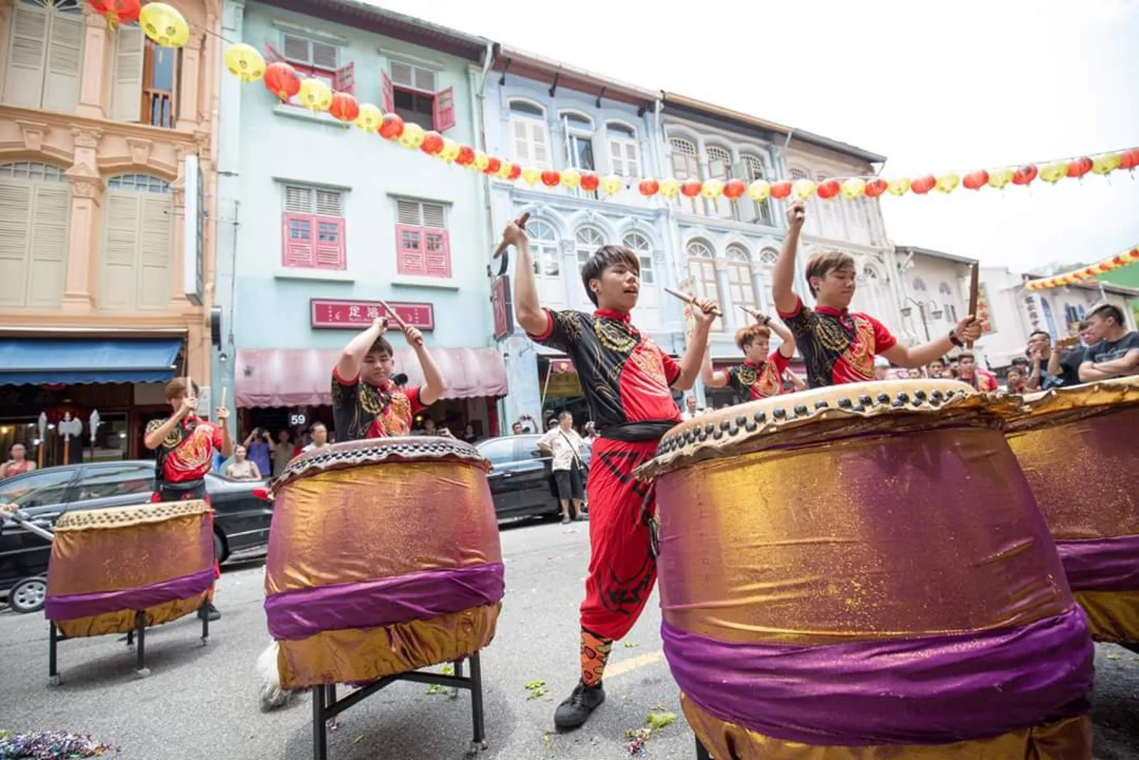 Lion dance drummer playing live percussion at a Singapore event